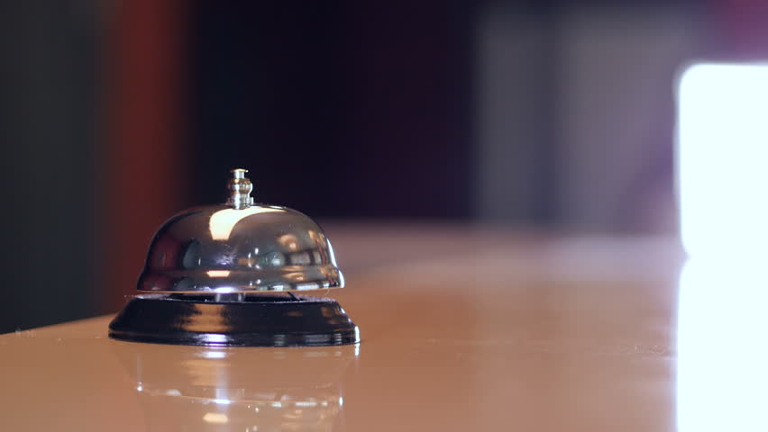 Person call on a old hotel bell on a wood stand and get chip key from hotel room. 4K. Royalty-Free Stock Footage #27119599