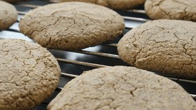 Tilting on healthy bread product on baking rack 4K 2160p 30fps UltraHD footage - Close-up of fresh baked cookie surface slow tilt 3840X2160 UHD video
