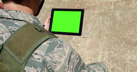 Military soldier using digital tablet during training exercise at boot camp