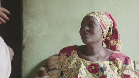 Nigeria - May 2016: Muslim midwife visiting a pregnant woman at home