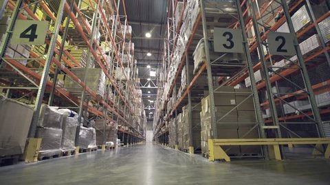 Interior of warehouse with racks full of cardboxes and goods