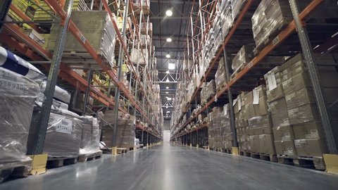 Interior of warehouse with racks full of cardboxes and goods