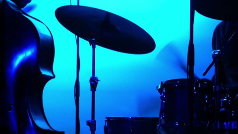Silhouette of a jazz band playing in a nightclub. Blue backlight.