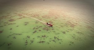 Drone flying around the boat and clear water at Phi-Phi island. Aerial video of traditional fishing boat. Thailand, phi phi islands, 2017.