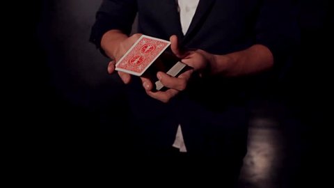Card trick. The magician's hands. / Card trick. The magician's hands. Man showing trick with playing cards