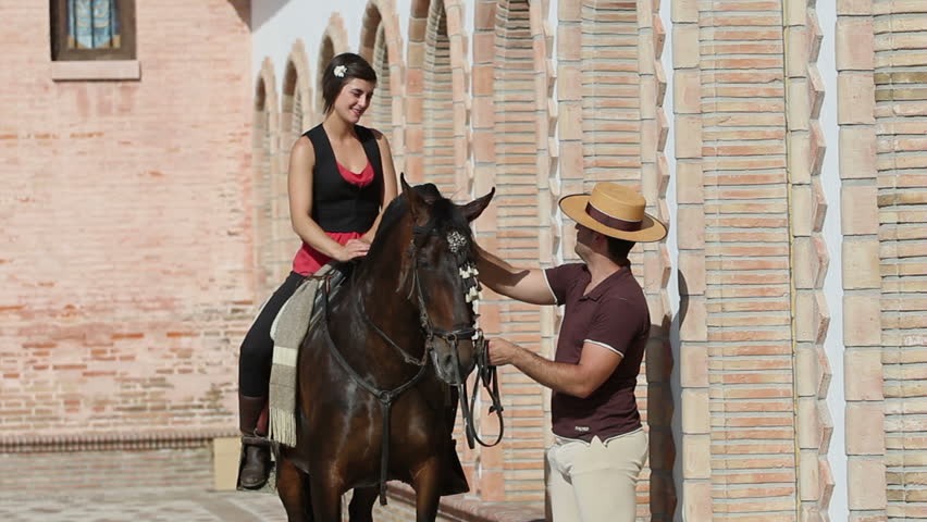 Man chatting to a woman on horseback in a village in Andalusia, Spain | Shutterstock HD Video #2714390