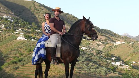 Man and woman riding a horse in Andalusia, Spain