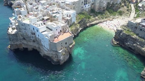 Polignano a Mare ( Bari , Italy ): heaven on earth. Coastal aerial 4k drone footage video above sea