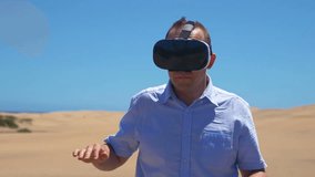 High quality video of man in VR glasses on sahara desert in 4K slow motion 60fps