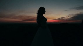 Beautiful wedding couple kissing on the sunset in the mountains