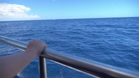 High quality video of a deck of a sailboat sailing on the ocean on a beautiful day in slow motion 180fps