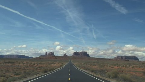a wide angle shot driving on hwy 163 towards monument valley in utah, usa