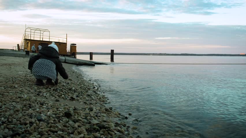 Daughter and mother throw stones at sea 4k