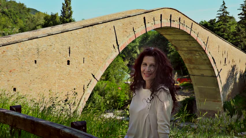 menopausal tourist near single span bridge in Europe