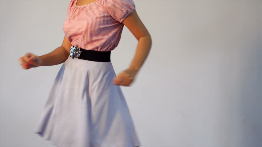 Young woman dressing in vintage fashion having a great time dancing the twist.
