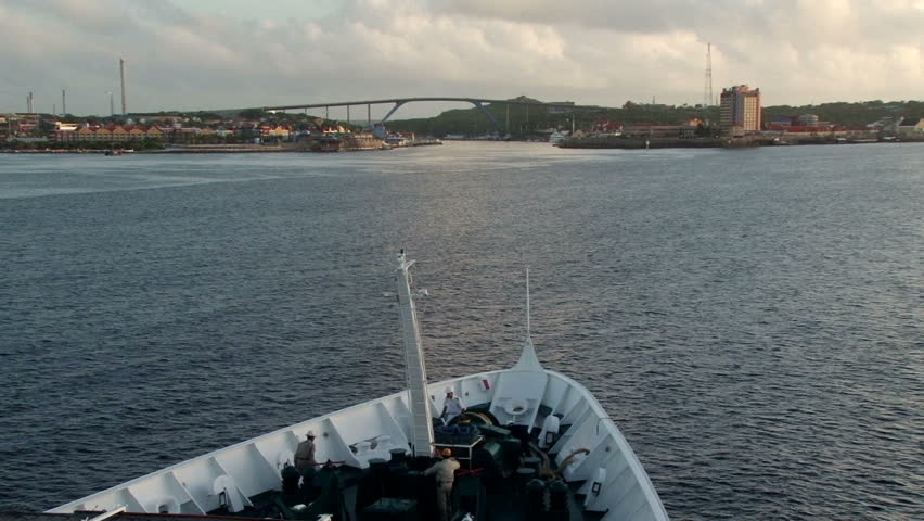 View of the bow of a ship as it enters the port of Willemstad, Curacao. The Juliana bridge is in the background