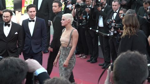 Kristen Stewart smiling, with gold top and long green Chanel dress, at the premiere of 120 Beats Per Minute at the Cannes Film Festival, 5/20/2017