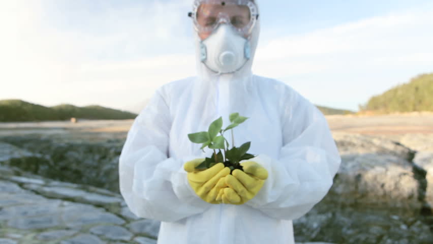 Chemical engineer showing a small new plant in the hands