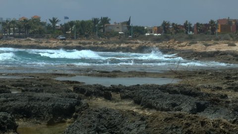 Cyprus, Ayia - Napa, rocks in the water and car on the beach. 