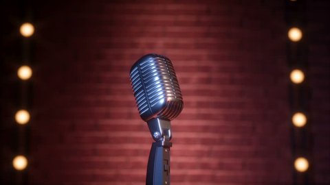 Vintage microphone on empty comedy club stage