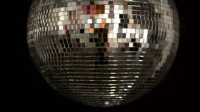 a funky discoball spinning and reflecting light. perfect clip for club visuals or party/celebration