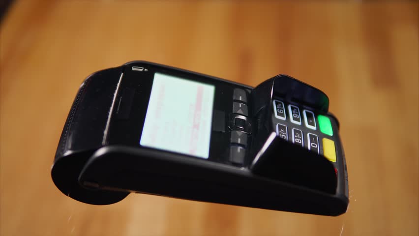 Close-up shot of a customer sliding credit card on bank terminal and entering a pin code. Noncash payments for goods and services Royalty-Free Stock Footage #27183829