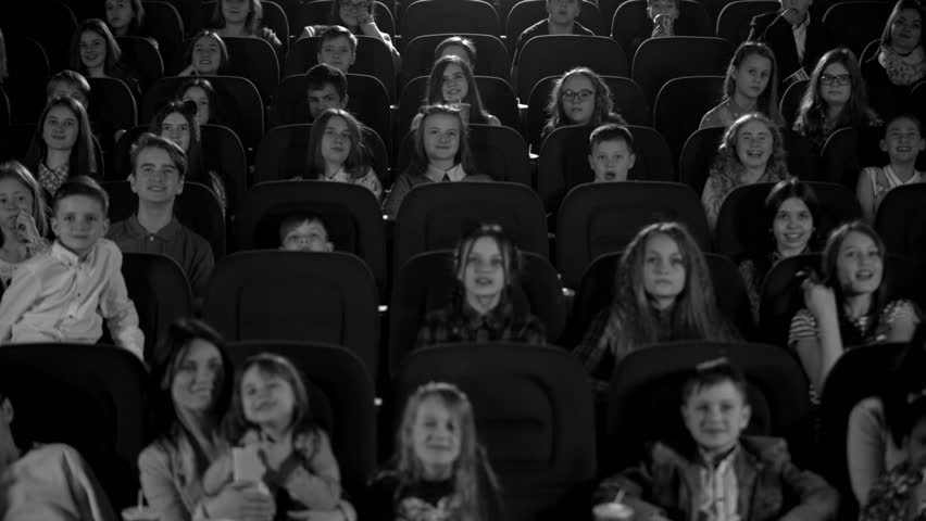 Happy children in the cinema looking a cartoon. Black and white picture. Royalty-Free Stock Footage #27186292