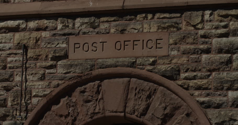 Old fashion post office sign in stone