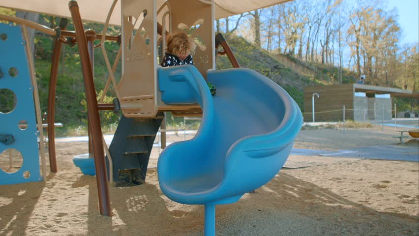 The boy slides down a toy car