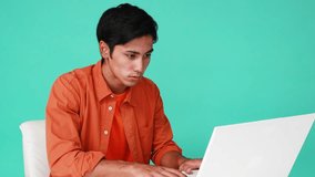 Stressed man working on computer. Negative human emotion face expression.
