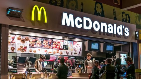 Lodz, Poland, May 06, 2017: Customer service just before closing in McDonald's restaurant, serving meals Big Macs, chips, french fries, and Coca Cola, 