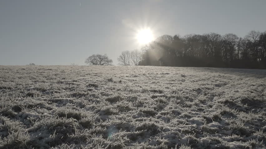 Hiker walking on frosty ground in early morning