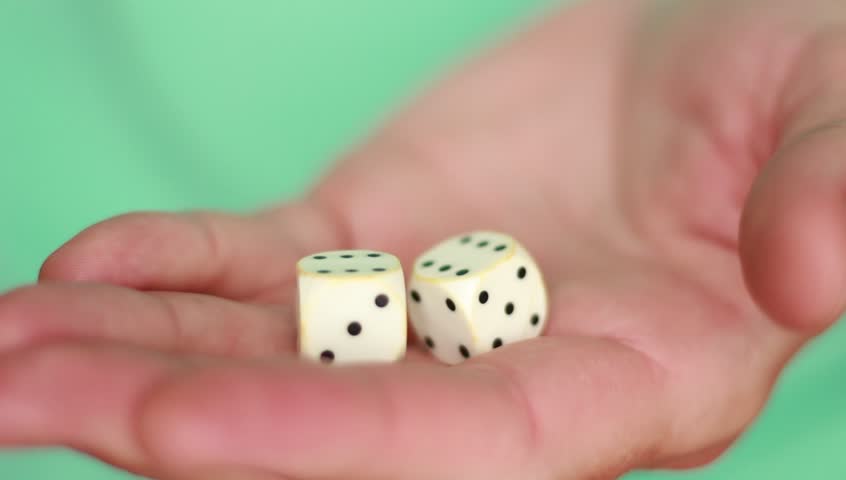 Holding white dice closeup
