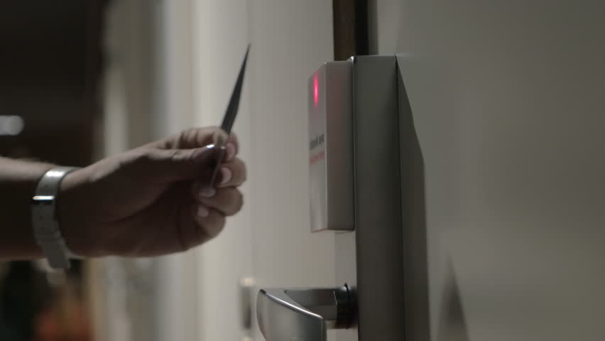 Close-up shot of a hotel guest using card key to open electronic lock of room door Royalty-Free Stock Footage #27220426