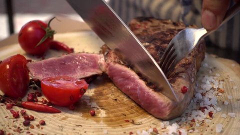 Close-up Cook cut steak with blood freshly grilled meat