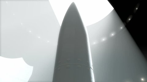 An upward view pan of an underground concrete missile silo opening up getting ready to launch an intercontinental ballistic missile 