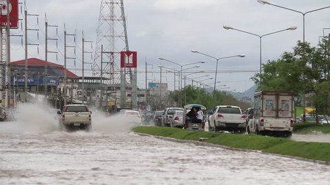 LOEI, THAILAND - MAY 18 2017: Car traffic on a flooded city road, Thailand Storm Flooding Bloor flooded from the heavy rain at LOEI Province, THAILAND on MAY 18 2017.
