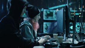 Team of Internationally Wanted Boy and Girl Hackers Organize Advanced Virus Attack on Corporate Servers. Place is Dark and Has Multiple Displays. Shot on RED EPIC-W 8K Helium Cinema Camera. - Powered by Shutterstock - Get 15% off with code: PIKWIZARD15