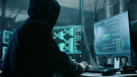Young Hacktivist Organizes Malware Attack on Global Scale. They're in Underground Secret Location Surrounded by Displays and Cables. Shot on RED EPIC-W 8K Helium Cinema Camera.