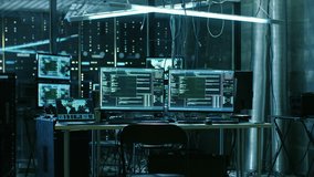 Dangerous Hooded Hacker Breaks into Government Data Servers and Infects Their System with a  Virus. His Hideout Place has Dark Atmosphere, Multiple Displays, Cables Everywhere. RED Cinema 4K UHD. - Powered by Shutterstock - Get 15% off with code: PIKWIZARD15