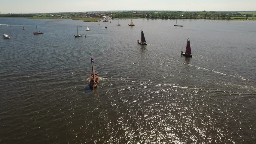 Aerial of typical Dutch botters ships with on the background fishers village Spakenburg / Amersfoort Royalty-Free Stock Footage #27249382