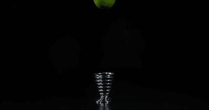Green Lemons, citrus aurantifolia, Fruit that Rebounds on an Egg Cup on Black Background, Slow Motion 4K