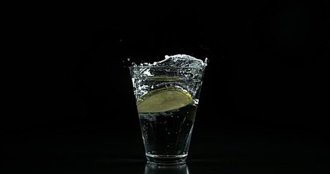Slice of Green Citrus, citrus aurantifolia, in a Glass, Slow Motion 4K