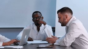 Multiracial group of doctors having discussion in office