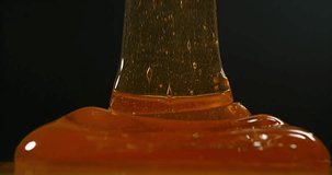 Honey Flowing against Black Background, Slow Motion 4K