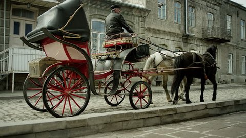 Riding vintage horse carriage on a cobble road .Horse-drawn Carriages runnig.    Shot on RED EPIC DRAGON Cinema Camera.