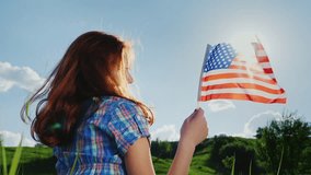 Young woman with the American flag in the sun.