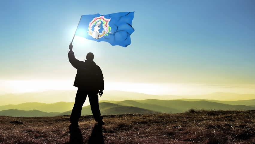 Successful silhouette man winner waving Northern Mariana Islands flag on top of the mountain peak, Cinemagraph LOOP background
