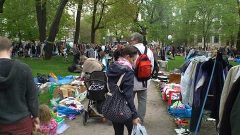 HELSINKI, FINLAND - MAY 27, 2017: A lot of people at the flea market in the city Park. The traditional day of the sale of unnecessary things, called in Finland Cleaning Day. Subjective camera