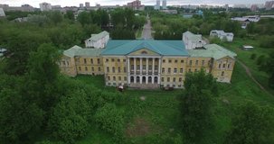 Aerial drone video with view of beautiful vintage architecture of Ivanovskoye Estate, views of main house and park in outskirts of Podolsk town in central Russia, south of Moscow